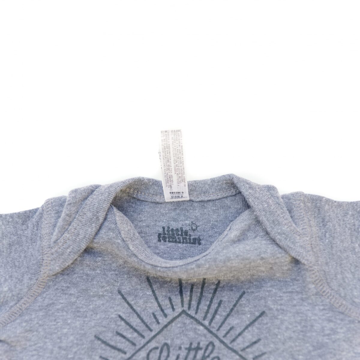 Little Feminist grey onesie inside label