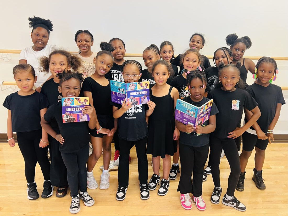 A dance class holding up copies of Juneteenth