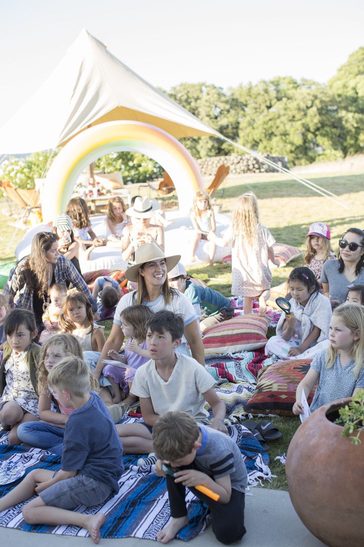 A big group story time with kids and grown-ups reading together
