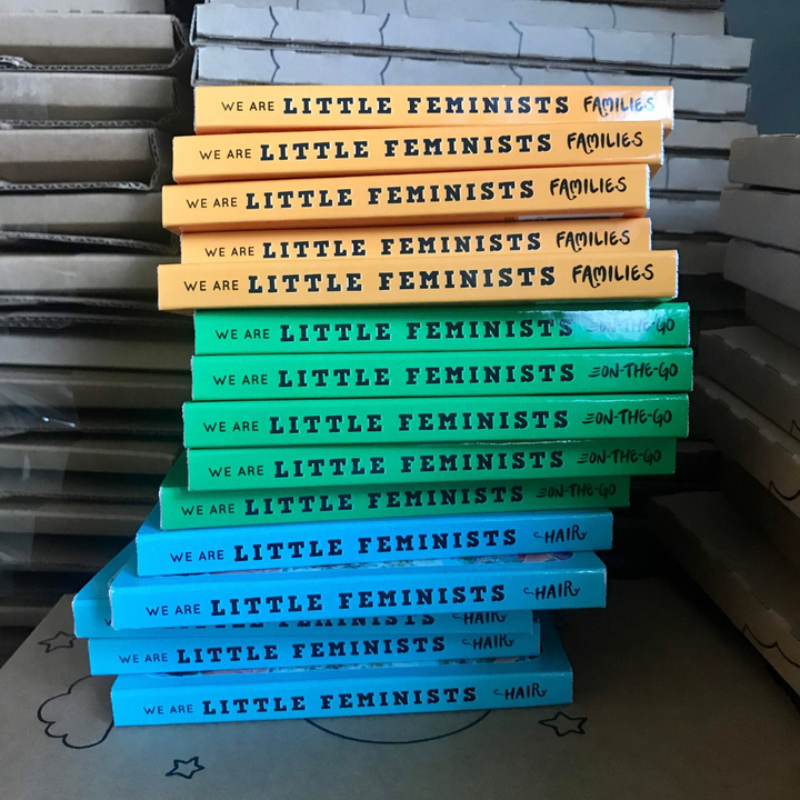 Stacks of Little Feminist Families, On-the-Go, and Hair board books.