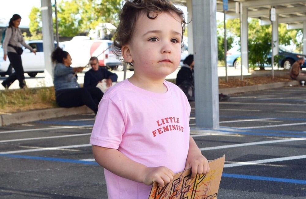 Little Feminist pink kid's shirt in action