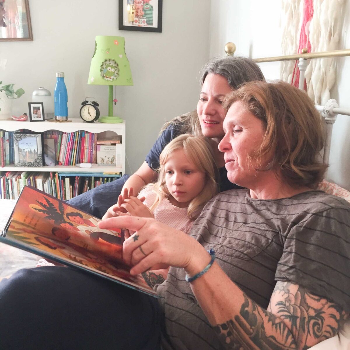 family reading book about refugees